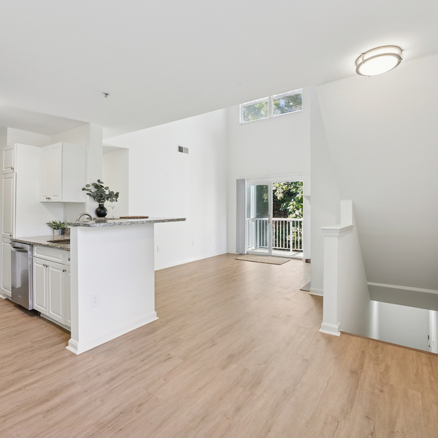 The Estates - Open Living Area With Kitchen And Staircase