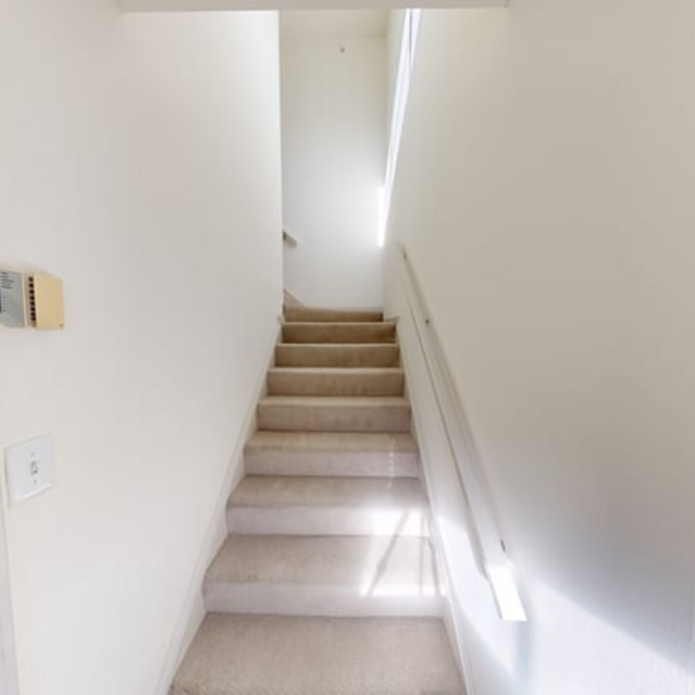 The Estates - Narrow Hallway Leading To Upper Floor