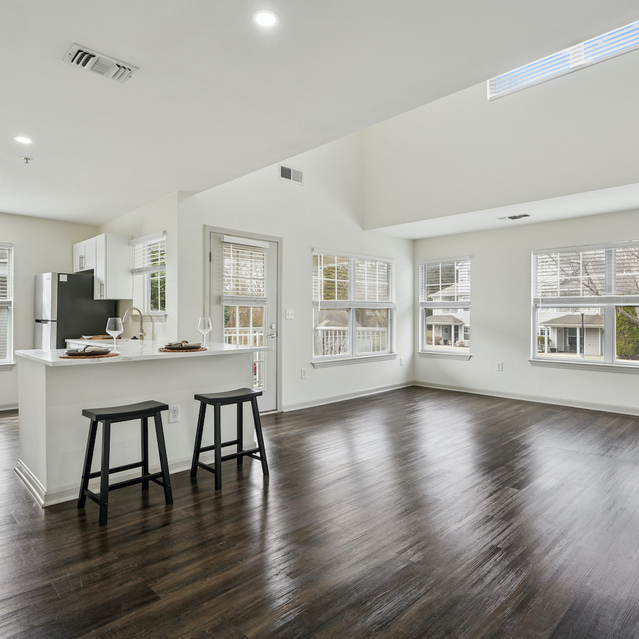 The Estates - Open Concept Living Area With Dark Flooring