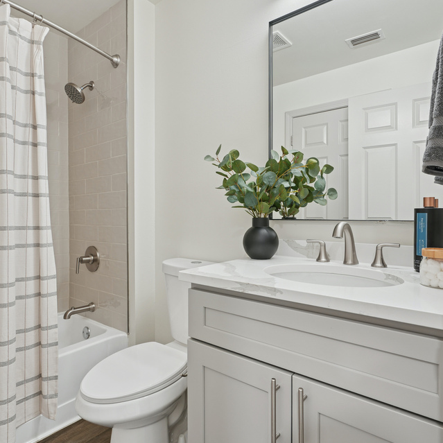 The Estates - Bathroom Vanity With Mirror And Greenery