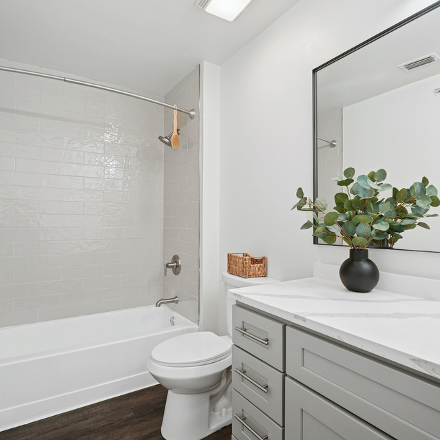 The Estates - Bathroom With Tub Shower And Vanity Mirror