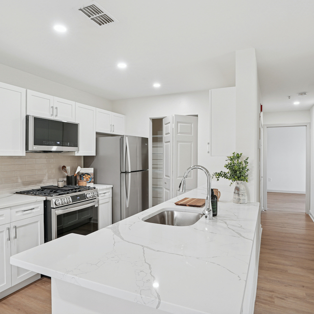 The Estates - Modern Kitchen With Island And Appliances