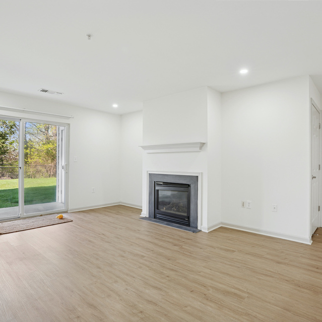 The Estates - Open Living Area With Fireplace And Sliding Doors