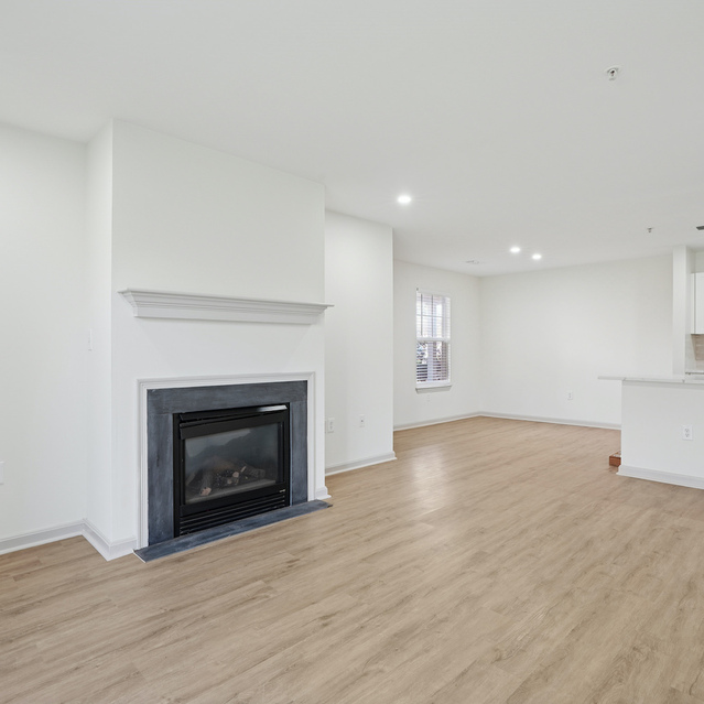 The Estates - Spacious Living Area With Fireplace And Wooden Flooring