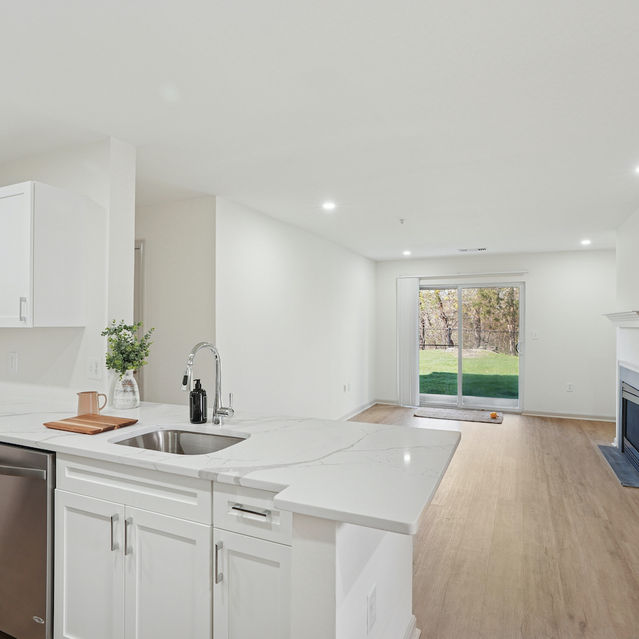 The Estates - Open Kitchen With Island Leading To Living Area