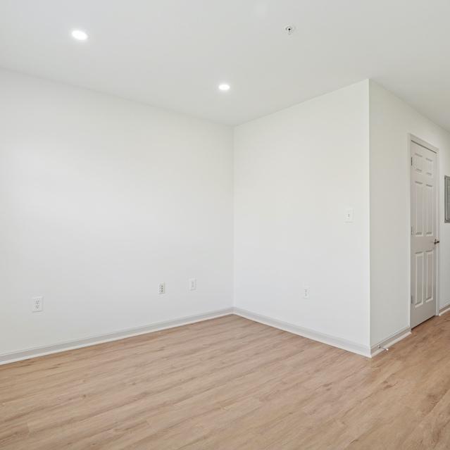 The Estates - Open Interior Space With Wood Flooring
